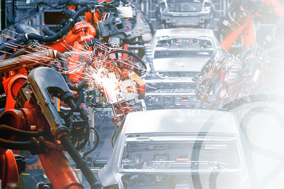 Robotic arms welding car bodies on an automotive assembly line.